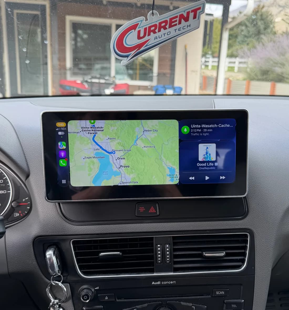 Large touchscreen with Apple CarPlay maps and music installed in a 2011 Audi Q5 dashboard