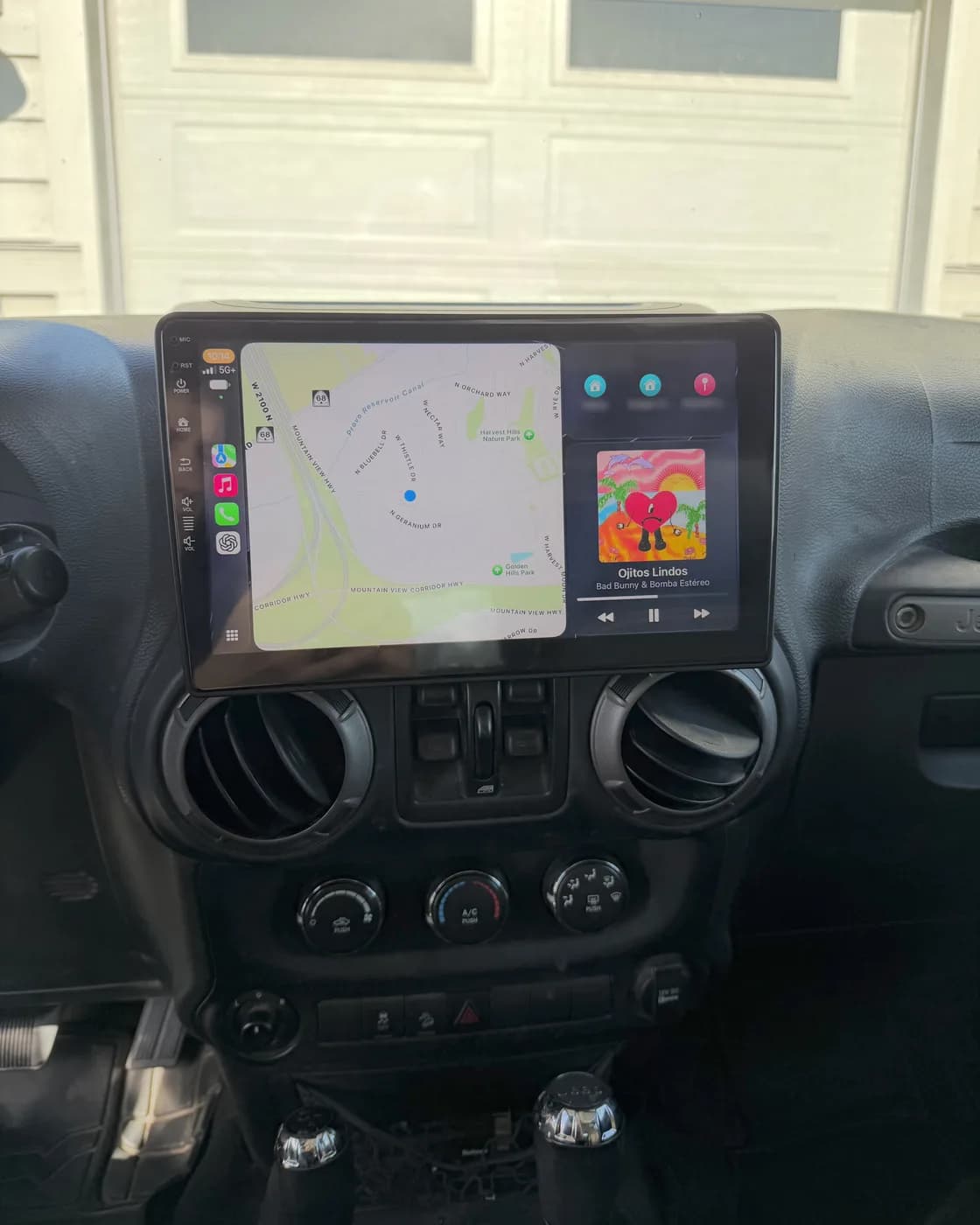 Apple CarPlay on a large touchscreen installed in a Jeep Wrangler dashboard
